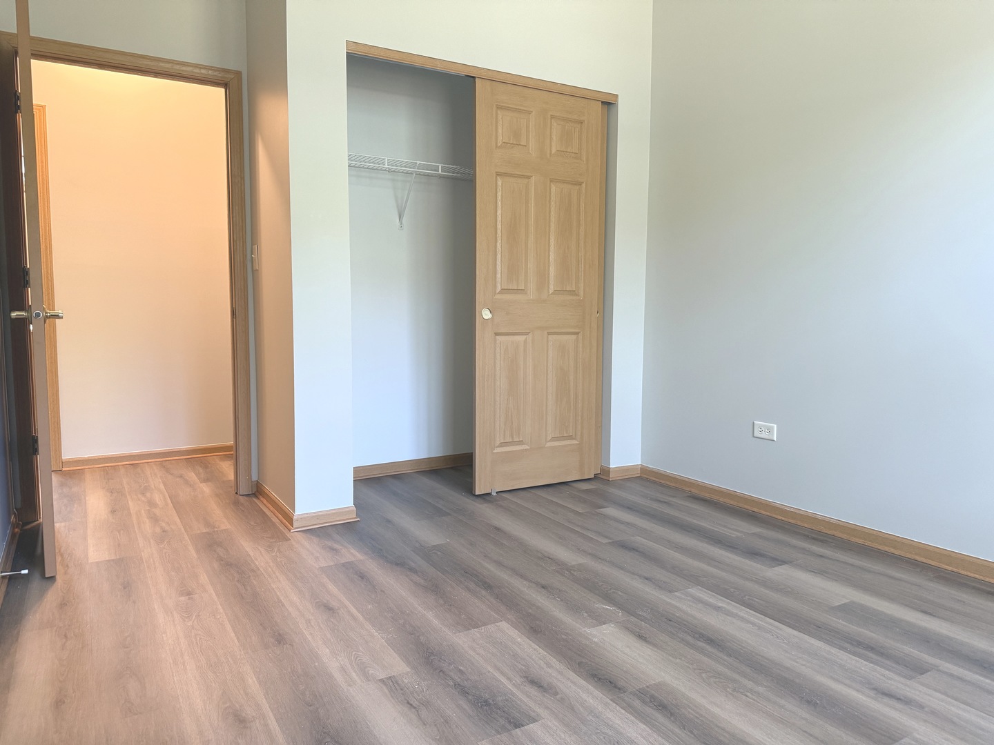 810 Woodewind Drive, Unit 810 Naperville, IL 60563 - Photo 13 of 16 an empty room with wooden floor and windows