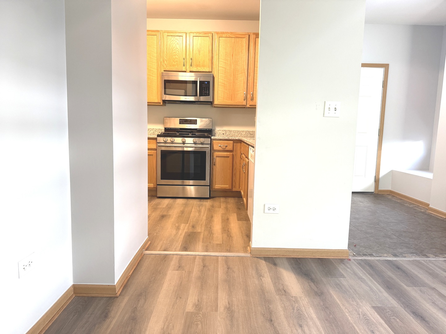 810 Woodewind Drive, Unit 810 Naperville, IL 60563 - Photo 5 of 16 a view of kitchen and wooden floor