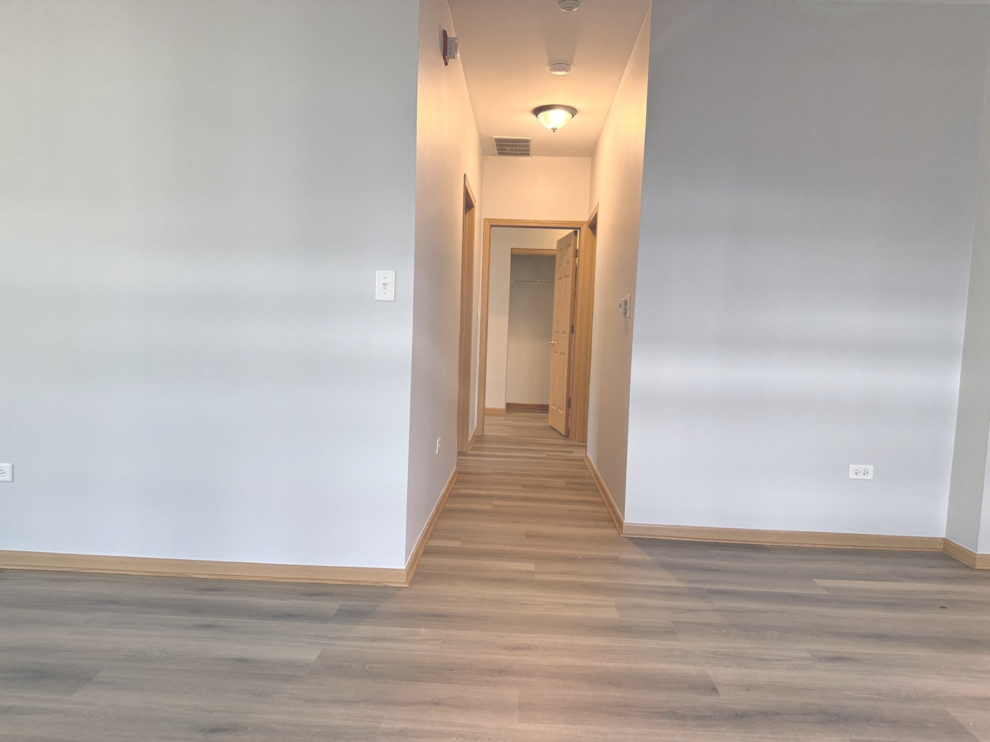 810 Woodewind Drive, Unit 810 Naperville, IL 60563 - Photo 10 of 16 a view of a hallway with wooden floor