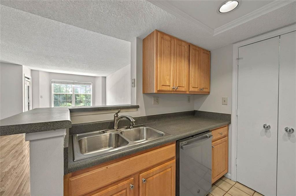 4106 Chastain Park Court Northeast Atlanta, GA 30342 - Photo 15 of 33 a kitchen with stainless steel appliances granite countertop a sink stove and cabinets