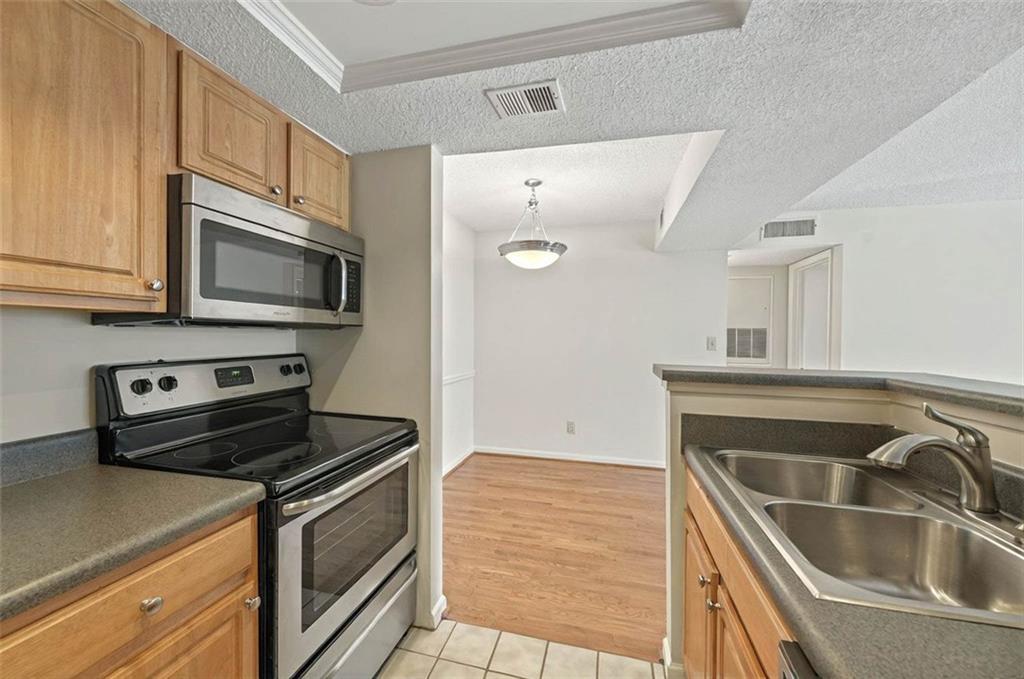 4106 Chastain Park Court Northeast Atlanta, GA 30342 - Photo 16 of 33 a kitchen with a sink stove and microwave