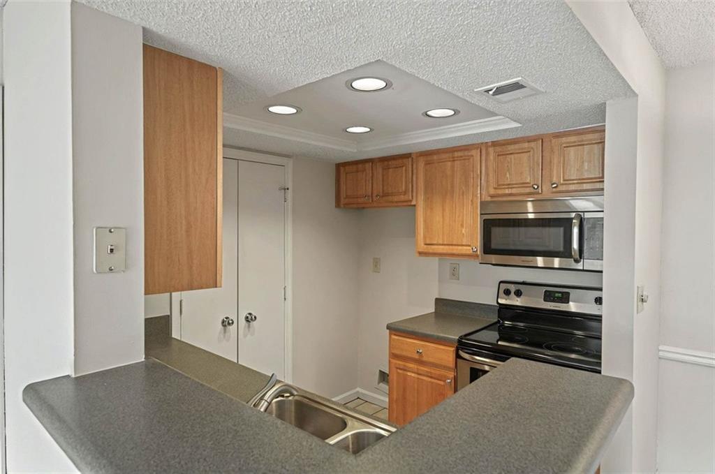 4106 Chastain Park Court Northeast Atlanta, GA 30342 - Photo 17 of 33 a kitchen with a refrigerator and a stove top oven