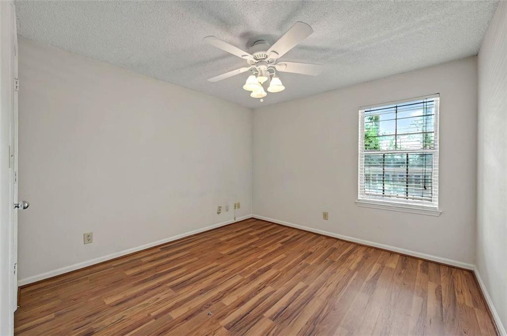 4106 Chastain Park Court Northeast Atlanta, GA 30342 - Photo 20 of 33 an empty room with wooden floor fan and windows