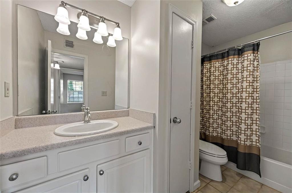 4106 Chastain Park Court Northeast Atlanta, GA 30342 - Photo 23 of 33 a bathroom with a sink a toilet and shower