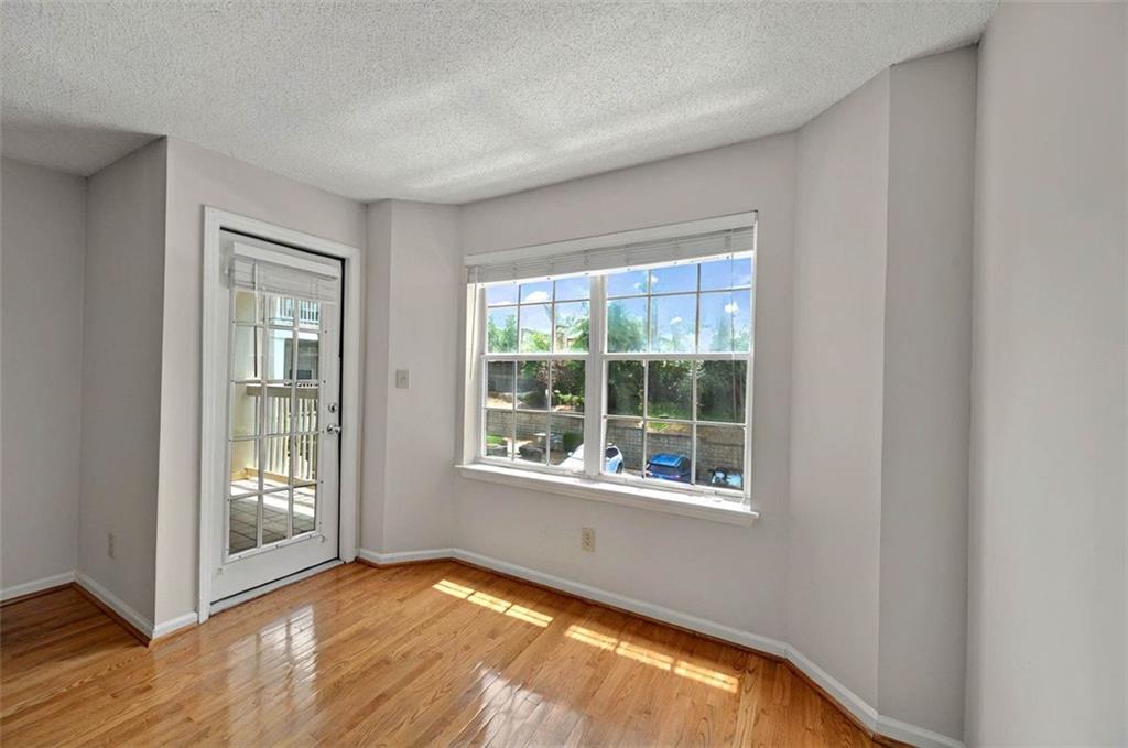 4106 Chastain Park Court Northeast Atlanta, GA 30342 - Photo 9 of 33 a view of an empty room with wooden floor and a window