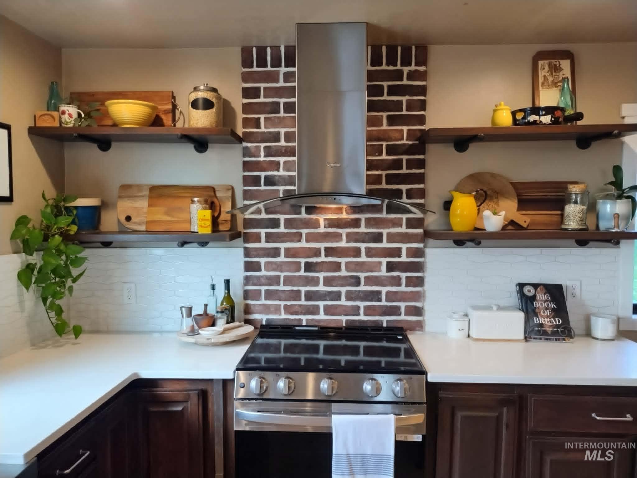 14526 Perfection Lane Caldwell, ID 83607 - Photo 12 of 47 Kitchen featuring a stainless steel range with a coordinating range hood, white countertops, and dark wood cabinetry