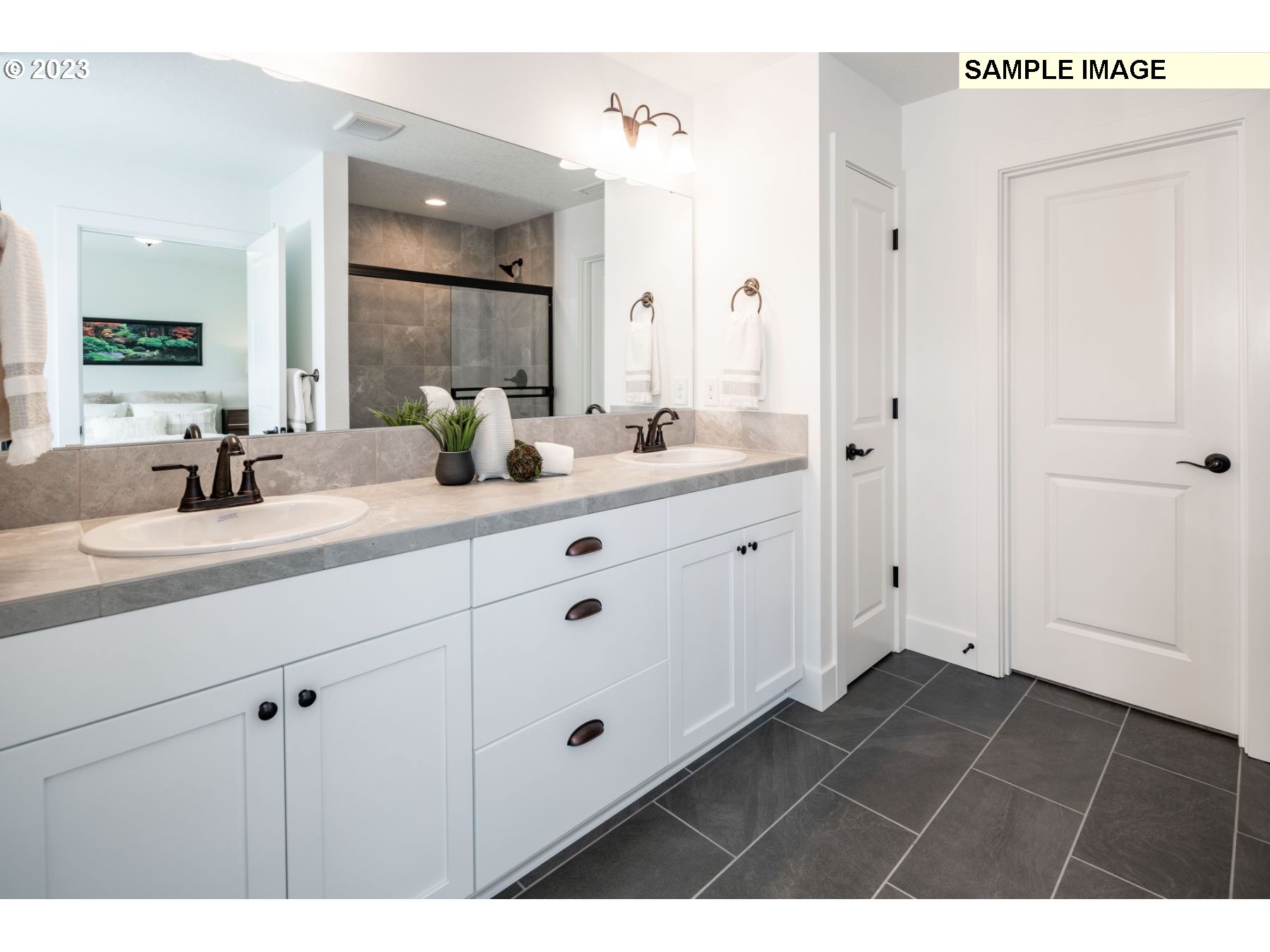 1020 Northwest 178th Street Ridgefield, WA 98642 - Photo 12 of 19 a bathroom with a double vanity sink a mirror and a shower