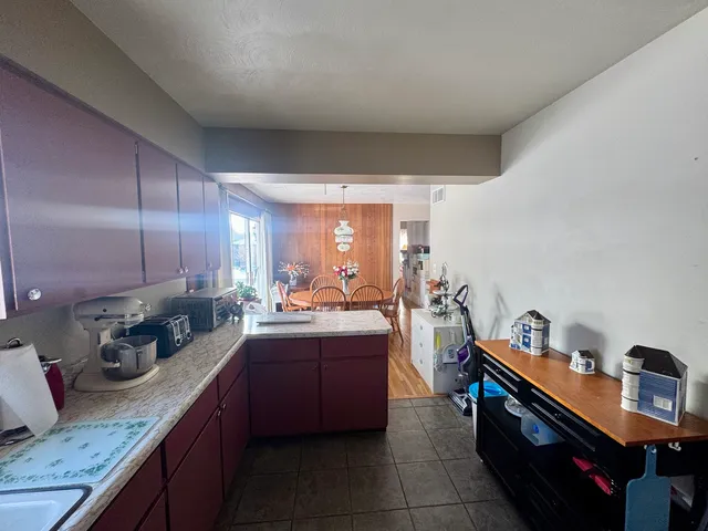 a kitchen with a sink cabinets and wooden floor