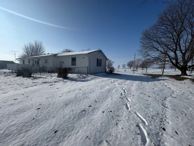 a view of a dirt road and a building