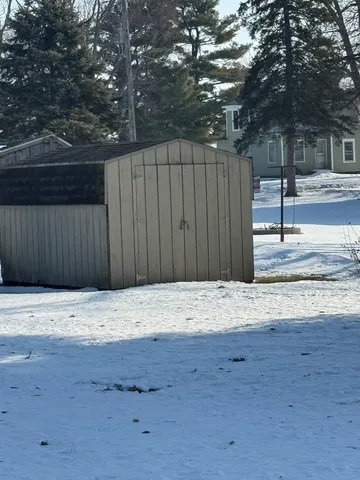 a wooden fence with trees in the background