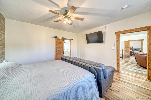 a bedroom with a bed and a flat screen tv