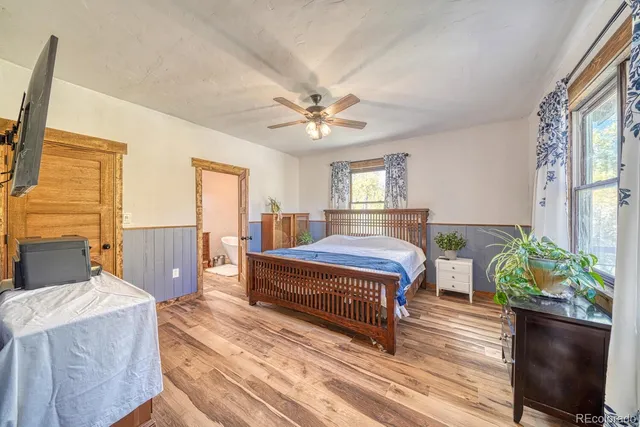 a bedroom with a bed dresser and a window