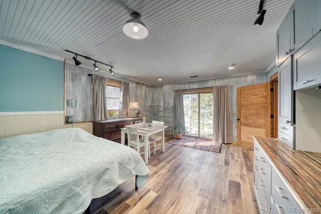 a spacious bedroom with a large bed and a large window