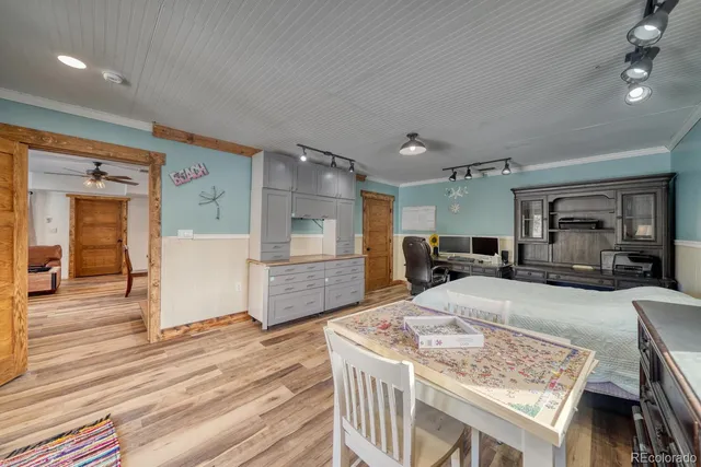 a large room with kitchen island a stove a table and chairs in it