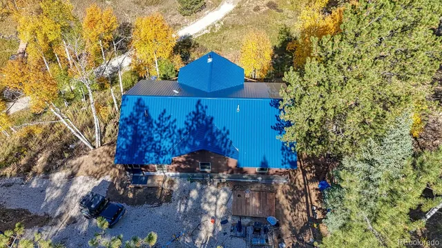 an aerial view of a house with a yard