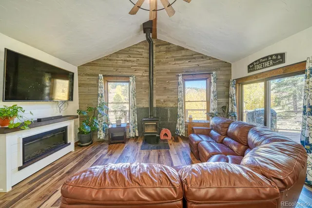 a living room with furniture fireplace and flat screen tv