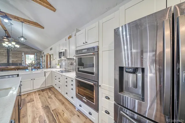 a kitchen with stainless steel appliances a refrigerator sink and cabinets