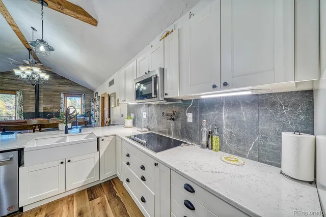 a kitchen that has a sink and a stove