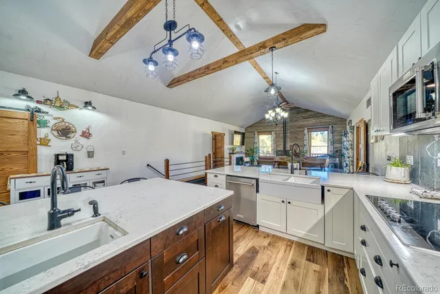 a kitchen with sink stove and cabinets