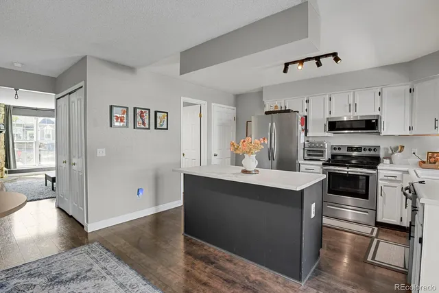 a kitchen with stainless steel appliances a stove refrigerator sink and microwave