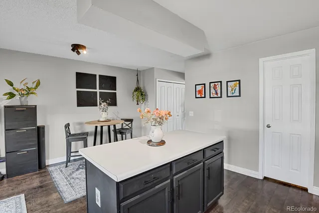 a view of kitchen island with cabinets and wooden floor