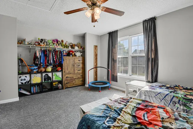 a bedroom with bed and a large window