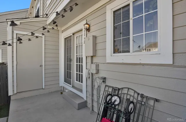 a view of a patio with dining table and chairs