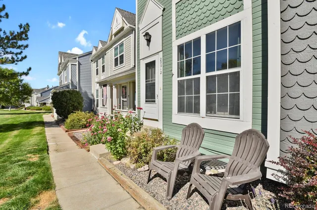 a view of a chair and table in the back yard of the house