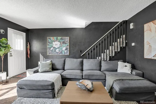 a living room with furniture and a potted plant