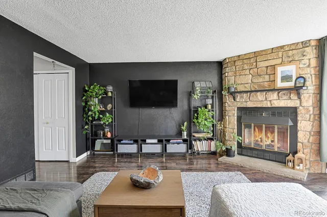 a living room with furniture and a fireplace