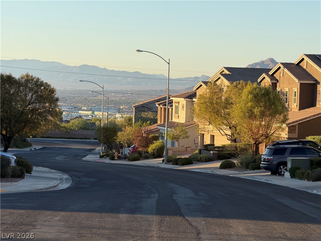 156 Dunblane Street Henderson, NV 89012 - Photo 2 of 2 A quiet neighborhood street offers captivating distant mountain and city views.