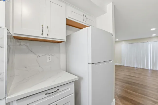 a white refrigerator freezer sitting inside of a kitchen