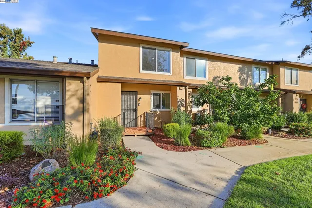 a front view of a house with garden