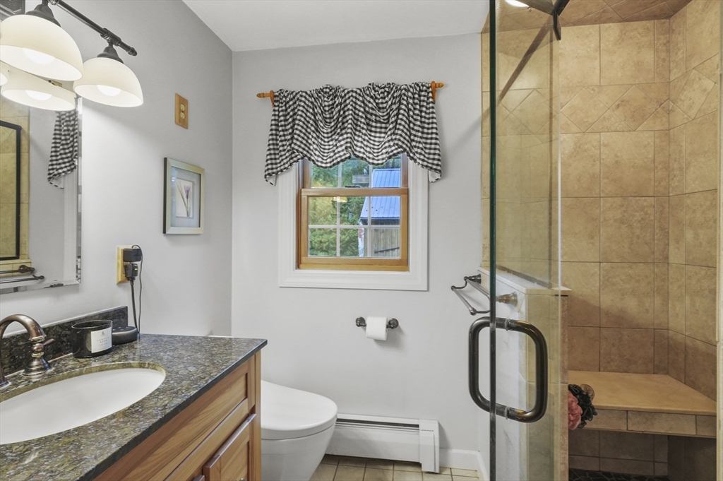 8 Beach Road Shrewsbury, MA 01545 - Photo 12 of 40 a bathroom with a granite countertop sink toilet and a mirror