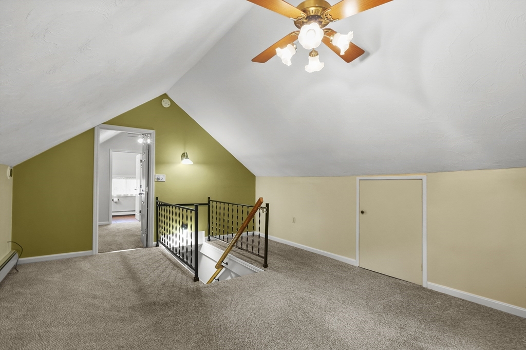 8 Beach Road Shrewsbury, MA 01545 - Photo 18 of 40 a bedroom with a bed and a chandelier