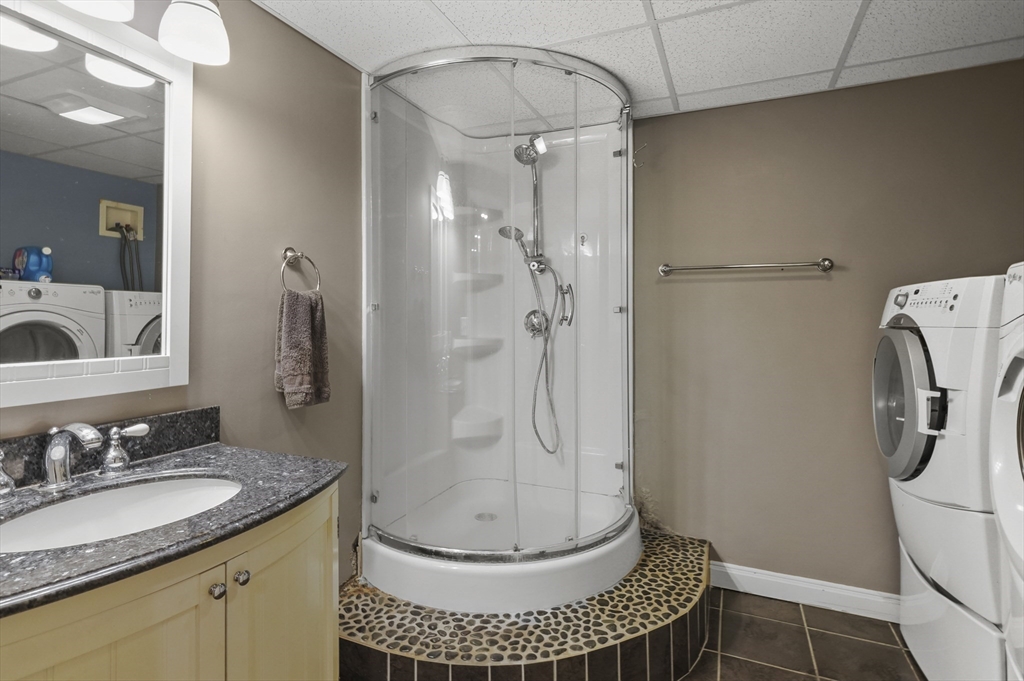 8 Beach Road Shrewsbury, MA 01545 - Photo 27 of 40 a bathroom with a granite countertop shower a mirror and a sink
