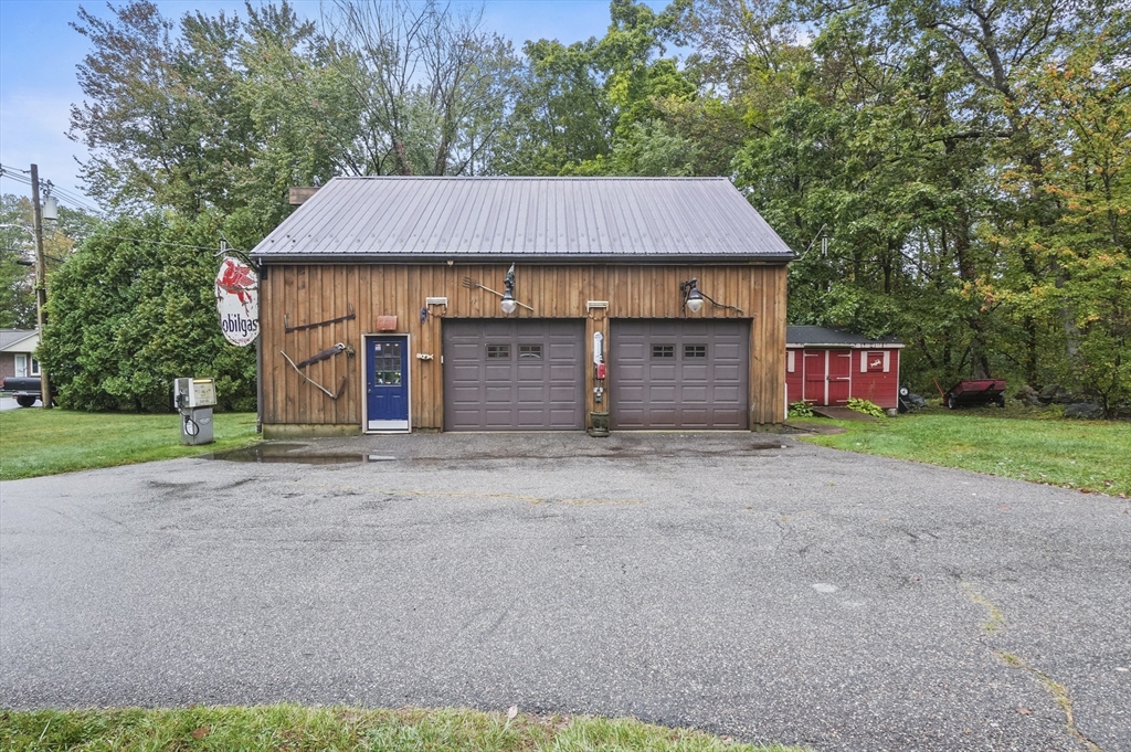 8 Beach Road Shrewsbury, MA 01545 - Photo 35 of 40 a front view of a house with a garden and garage