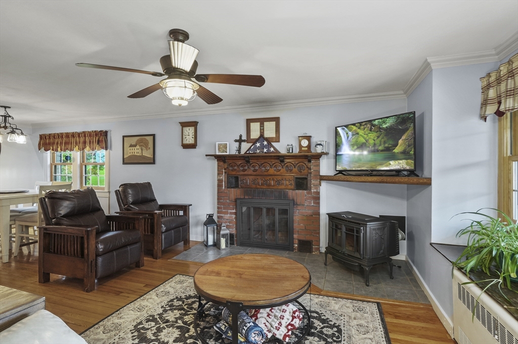 8 Beach Road Shrewsbury, MA 01545 - Photo 5 of 40 a living room with furniture a flat screen tv and a fireplace