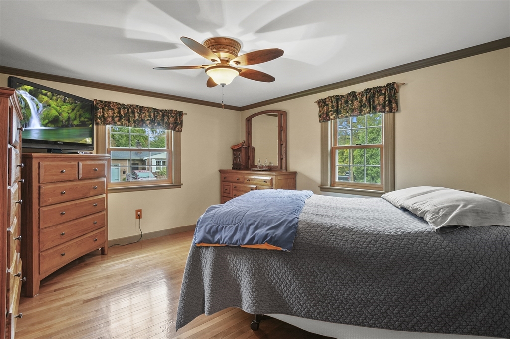 8 Beach Road Shrewsbury, MA 01545 - Photo 10 of 40 a bedroom with a bed and a dresser next to a window