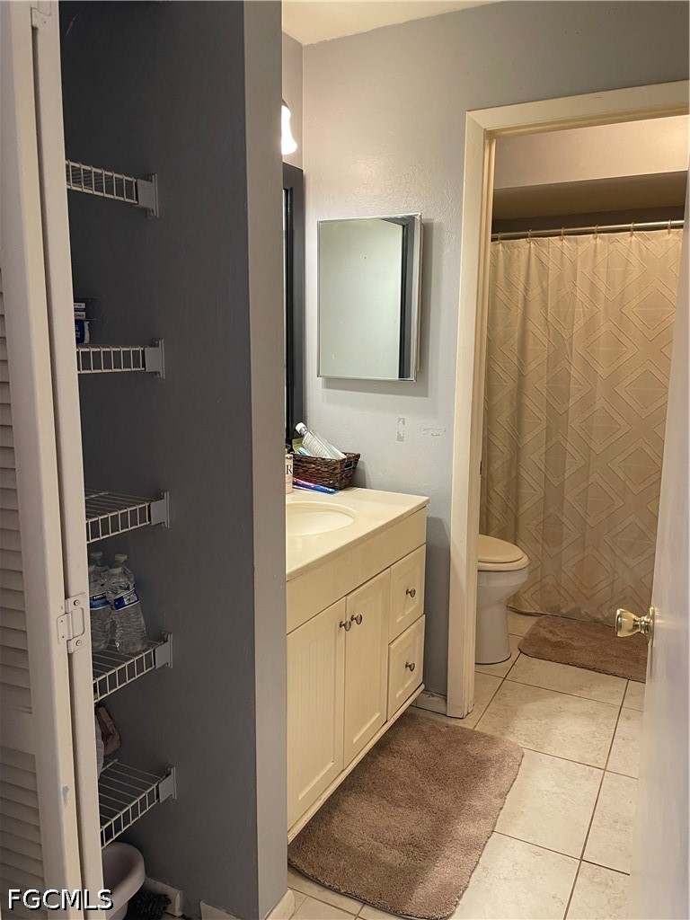 2239 Lotus Road Fort Myers, FL 33905 - Photo 16 of 26 a spacious bathroom with a double vanity sink toilet and a mirror
