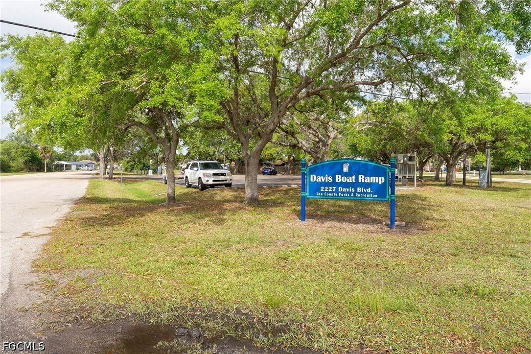 2239 Lotus Road Fort Myers, FL 33905 - Photo 20 of 26 a sign board with yard and trees in the background