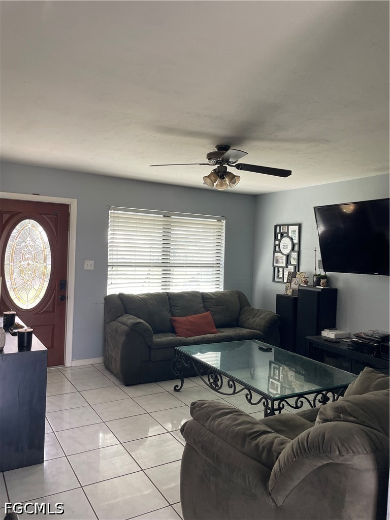 2239 Lotus Road Fort Myers, FL 33905 - Photo 4 of 26 a living room with furniture a window and a flat screen tv
