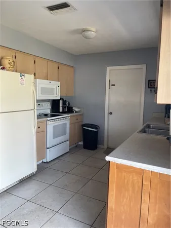a kitchen with a sink a stove and refrigerator