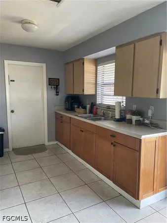 a kitchen with stainless steel appliances a sink window and cabinets