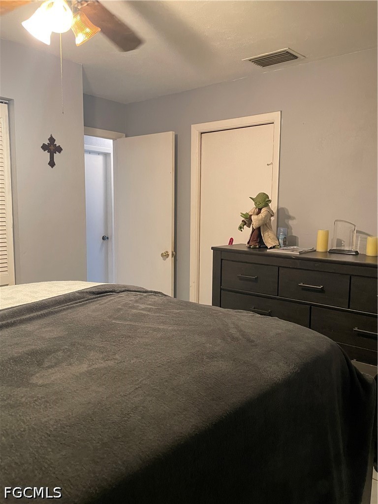 2239 Lotus Road Fort Myers, FL 33905 - Photo 10 of 26 a bedroom with a bed and a mirror