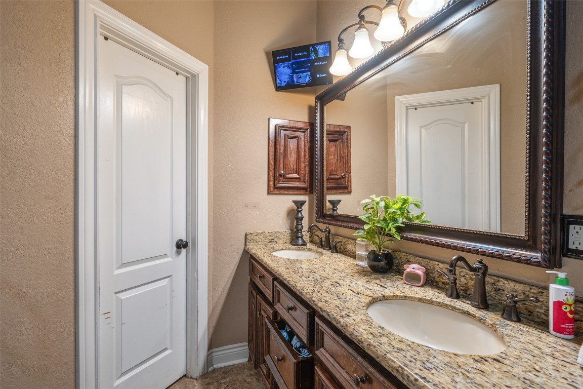 1508 Miami Road Pasadena, TX 77502 - Photo 11 of 17 a bathroom with a granite countertop double vanity sink and a mirror
