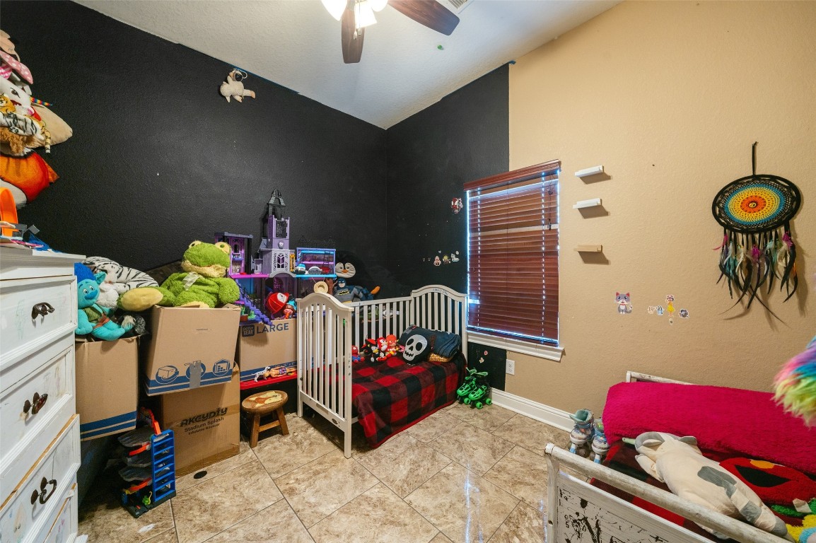 1508 Miami Road Pasadena, TX 77502 - Photo 12 of 17 a bedroom with furniture and a chair