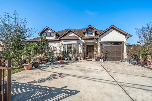 a front view of a house with yard and parking