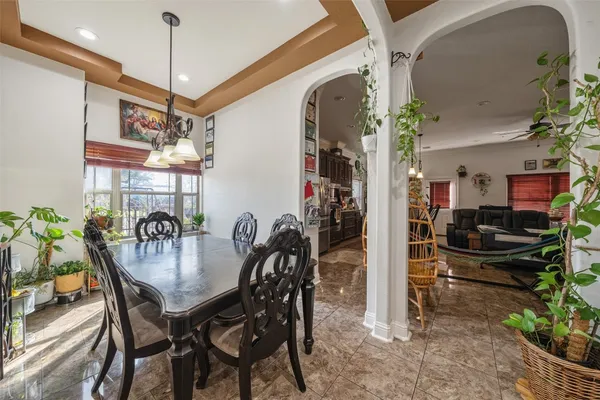a dining room with furniture and chandelier