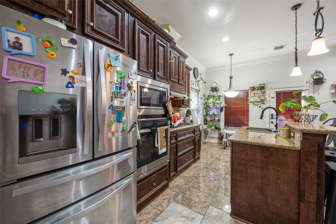 1508 Miami Road Pasadena, TX 77502 - Photo 5 of 17 a kitchen with stainless steel appliances granite countertop a refrigerator and a stove